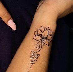 a woman's arm with a tattoo on it that says love and a lotus