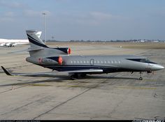 an airplane is parked on the tarmac with other planes in the backgroud