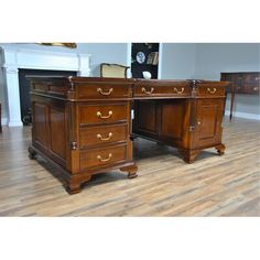 two wooden desks sitting on top of a hard wood floor