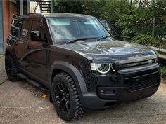 a black suv parked in front of a building