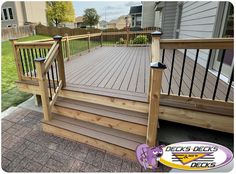 a wooden deck with railing and hand rail