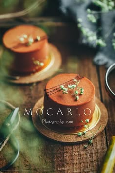 two cakes sitting on top of wooden plates