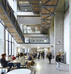 people are sitting at tables in an open building