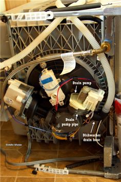 the inside of a dishwasher with wires attached to it and other parts labeled