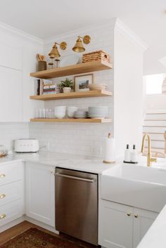 the kitchen is clean and ready to be used for cooking or baking, with white cabinets and open shelving