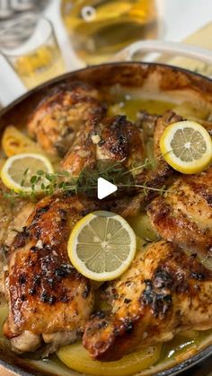 chicken with lemons and herbs in a pan