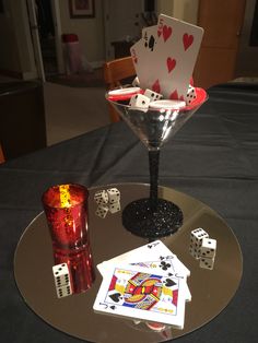 a martini glass with playing cards and dice on it