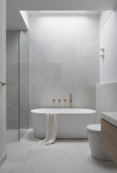 a white bath tub sitting next to a toilet