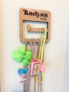 Need a baby shower gift or a sweet gift for a girl ? This is the perfect way to help organize the nursery with baby bows and headbands.  THINGS TO KNOW/DETAILS OPTIONS:  This option of our bow hanger comes engraved only. It is about 4.5inx4.5in and is about 16 inches long with the macrame. It is a perfect way to hang hair ties, headbands, bows, clips and more!  We also love custom orders so if you would like a different variation of this item or a customization of this item please send us a message and we would be happy to help! IMPORTANT SHIPPING INFORMATION Our turnaround time for receiving your item is about 1-2 weeks. We typically use USPS for smaller items and UPS for our larger/heavier items. If you need your item sooner, we offer two ways to rush your item at an additional charge. W Hair Accessory Organizer, Hair Clip Organizer, Hair Tie Holder, Clip Organizer, Bow Storage, Hair Bow Organizer, Tie Holder, Accessory Organizer, Headband Organizer