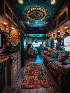 the interior of an rv decorated with colorful rugs and decor on the walls, windows, and ceiling