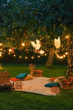 an outdoor seating area is lit up with fairy lights