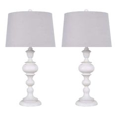 pair of white table lamps with linen shades on each lamp and one light turned off