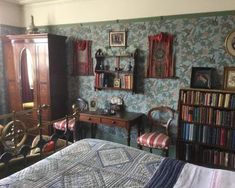 a bedroom with bookshelves, dresser and bed