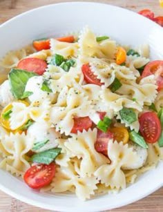 a white bowl filled with pasta and vegetables