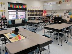 an empty classroom with desks and chairs