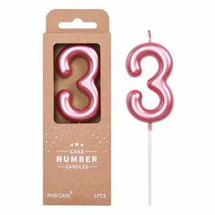 a pink cake number candle in a box