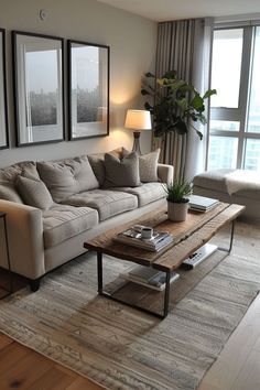 a living room filled with furniture and a large window next to a wooden coffee table