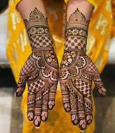 two hands with henna designs on them