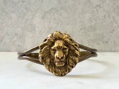 Lion's Mane Cuff...  I attached an antique brass lion's head brass stamping to the top of a dark antique brass cuff bracelet.  The cuff is adjustable. This would be a great gift for men and women! This cuff will fit medium to large wrists.  You will receive this fabulous lion's head cuff gift wrapped!  A perfect gift for someone with a Leo birthday! Nature inspired necklaces are listed here! https://www.etsy.com/shop/DaysLongGone?section_id=6063593 LION lockets listed in this section! https://ww Birthday Nature, Ear Curation, Lion Gifts, Leo Birthday, Lion's Mane, Brass Cuff Bracelet, Twisted Metal, Photo Locket Necklace, Brass Cuff