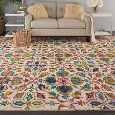 a living room with a couch and rug on the floor