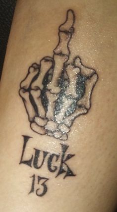 a close up of a person's leg with a tattoo on it that says luck 13