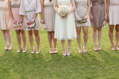 a group of women standing next to each other on top of a lush green field