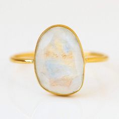 The moonstone steals the show in this gorgeous ring from Leah Alexandra.  This beauty features a slice of natural moonstone set in ultra delicate 14k yellow gold vermeil. Moonstone 14k yellow gold vermeil plate Sterling silver base Local Eclectic, Rainbow Moonstone Ring, Gem Ring, Vermeil Jewelry, Topaz Stone, Opal Earrings, Elegant Ring, Gold Plated Rings, Moonstone Ring