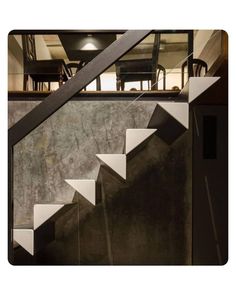 an image of stairs going up to the top floor