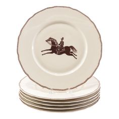 a stack of white plates with a black horse and rider on the front one plate has four smaller plates stacked next to each other