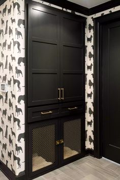 a black and white dog themed wallpaper in a room with wooden floors, built - in cabinets, and doors