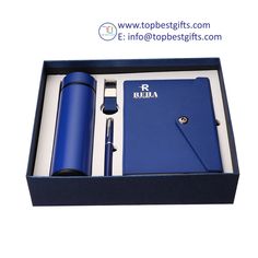 a blue pen and notebook in a gift box with the lid open to reveal it's contents