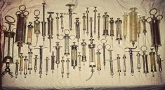 an assortment of old fashioned medical instruments on a table with a white sheet in the background