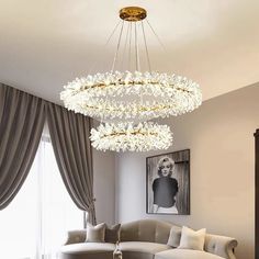 a living room with a couch, chair and chandelier hanging from the ceiling