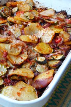 a casserole dish filled with potatoes and vegetables