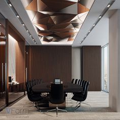 a conference room with wooden paneling and black leather chairs in front of a round table