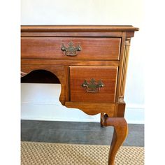 an old wooden desk with drawers on it