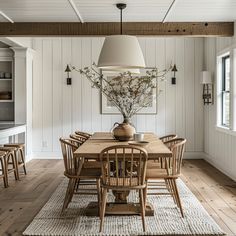 the dining room table is surrounded by wooden chairs