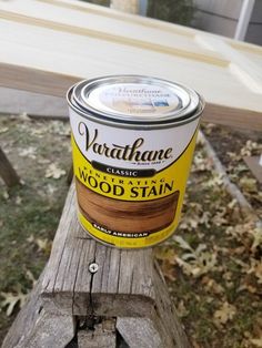 a can of wood stain sitting on top of a wooden bench