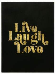 the words live laugh love are written in gold foil on black paper with white ink