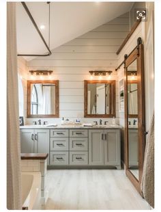 a large bathroom with double sinks and mirrors