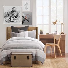 a bed room with a neatly made bed and pictures on the wall