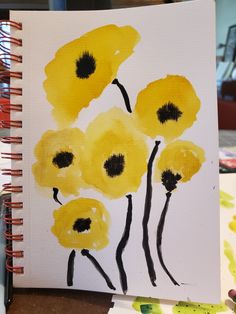 an art journal with yellow flowers painted on it