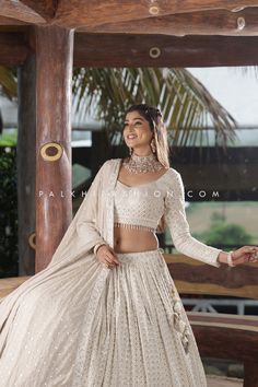 Elegance Unveiled in Every thread. Step into Splendor with this beige color designer lehenga choli from palkhi fashion. This stunning attire is highlighted with pure georgette fabric, attractive petite sequin embroidery, lakhanvi, and chikankari threadwork. The matching full-sleeved blouse is enriched with eye-catching work & style. Gets into the trend with full sleeves blouse and contemporary charm. It comes with a pure georgette full-length lakhanvi work pure georgette dupatta, which adds extr White Chikan Blouse Design, White Lakhnavi Lehenga, White Lehenga Choli Bridal, Simple And Elegant Lehenga Designs, Georgette Lahenga Design, Off White Lengha Lehenga Choli, Lehenga Designs With Sleeves, Full Sleeves Lehenga Designs, Full Length Blouse Designs For Lehenga