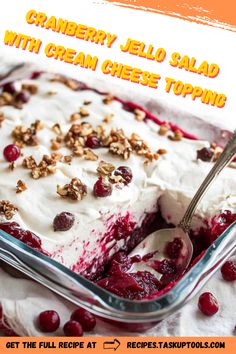 cranberry jello salad with cream cheese topping in a glass casserole dish