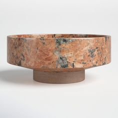 a marble bowl sitting on top of a wooden stand