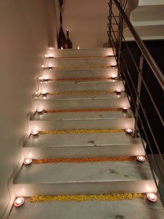 some candles are lit up on the stairs