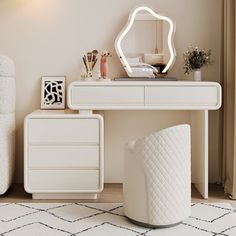 a white dressing table with a mirror and stool