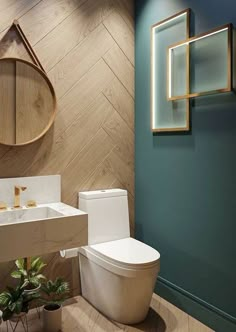 a bathroom with a toilet, sink and mirror in the wall next to potted plants