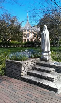 a statue in the middle of a brick walkway