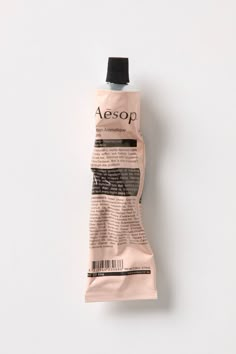 an empty tube of aesop on a white background with the word aesop in it